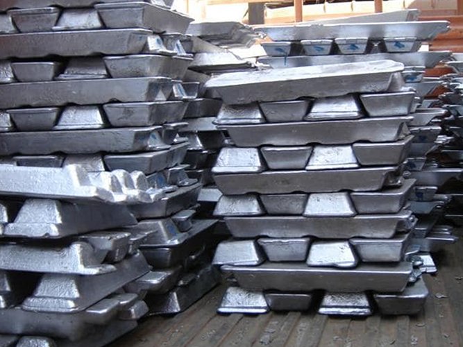 Stacks of silver aluminium ingots in a warehouse