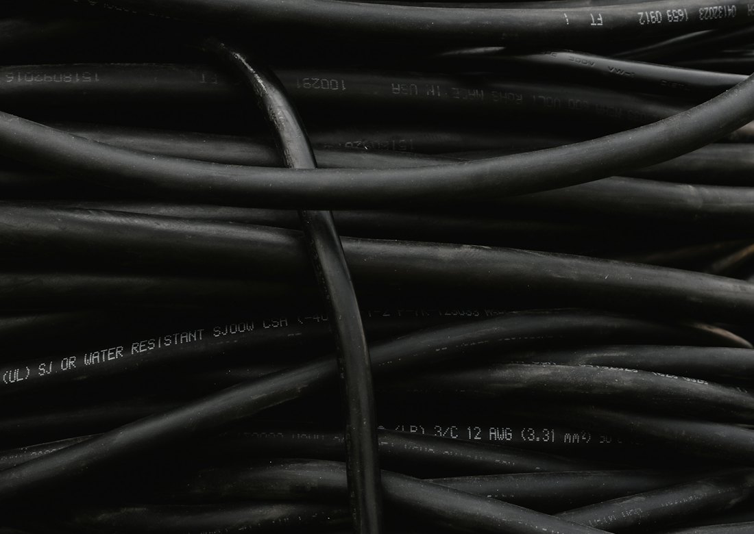 Coiled black PVC-insulated electrical cables